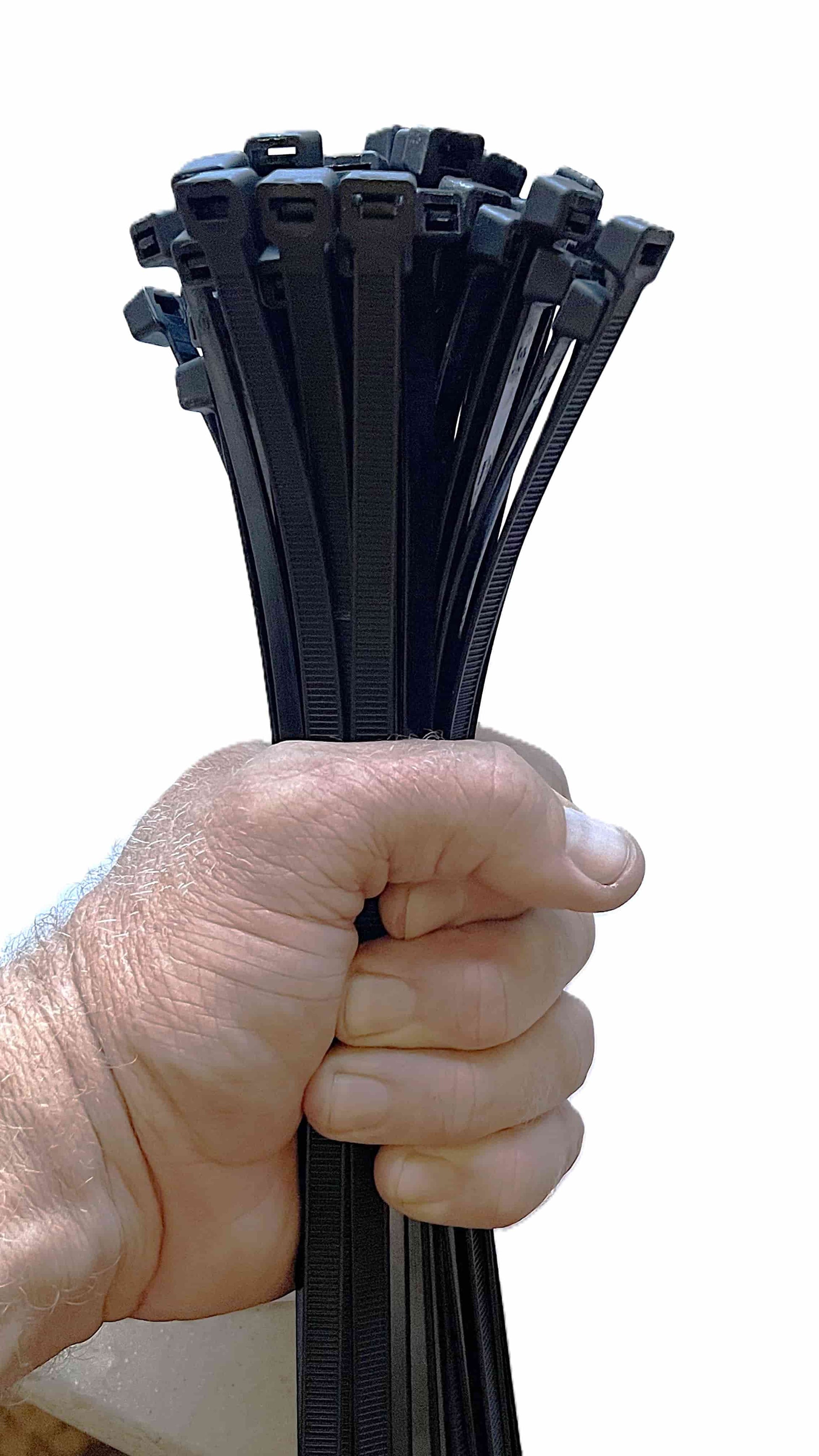 Worker holding a bundle of 12-inch black heavy-duty zip ties for organizing cables.