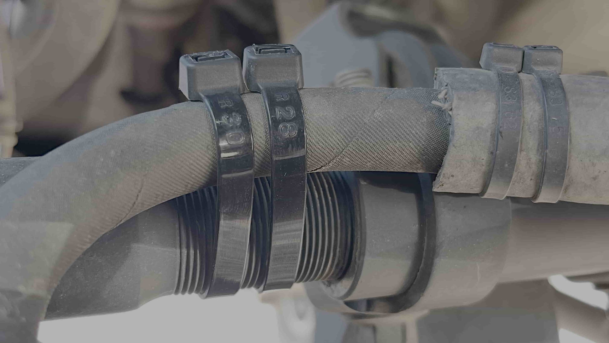 Close-up of 12-inch black industrial strength zip ties showcasing durable construction.