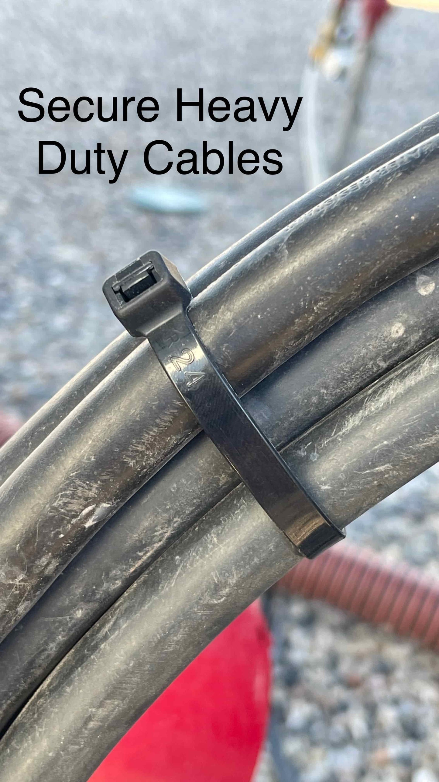 Black 12-inch heavy-duty zip ties fastening industrial cables for organized installations.