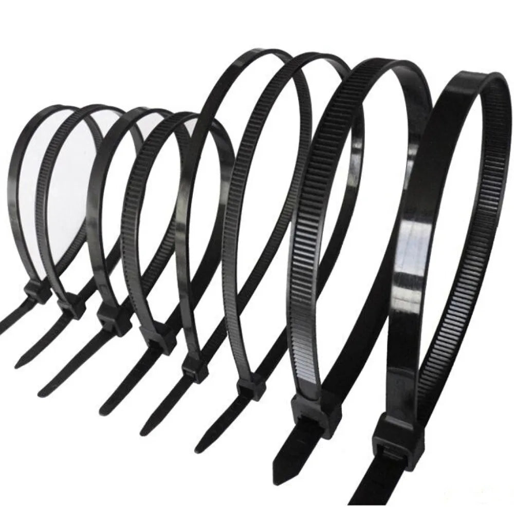 Various sizes of black self-locking zip ties arranged in a row, part of a 100-pack for diverse fastening needs.