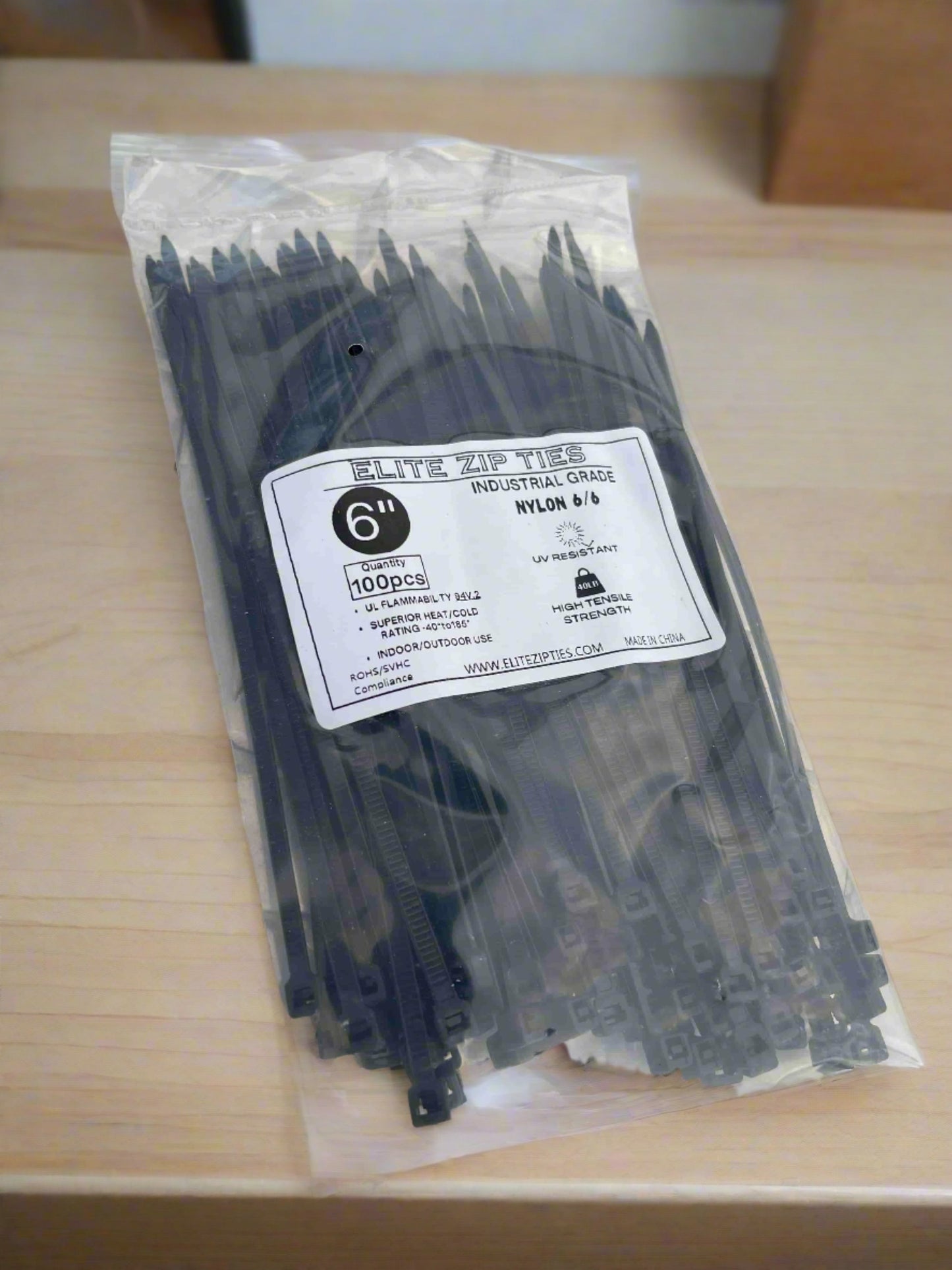 6-inch black industrial-grade nylon zip ties in a 100-pack, UV resistant with high tensile strength, displayed on a metallic surface.